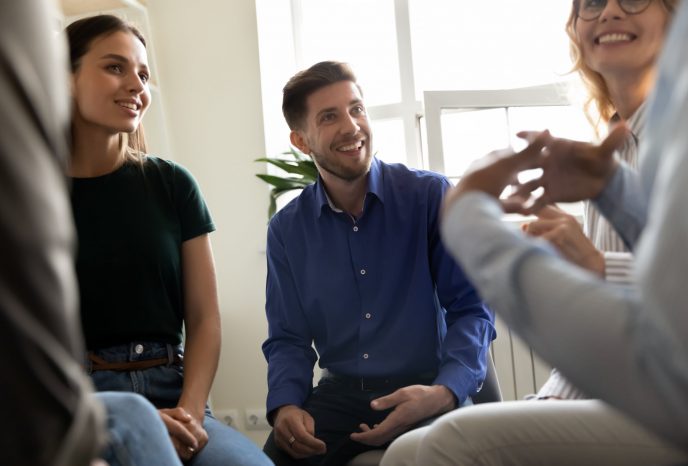 Diverse people attending at group therapy session listening psychologist counsellor, sharing personal stories, supporting overcome struggle with addiction together, psychotherapy meeting rehab concept